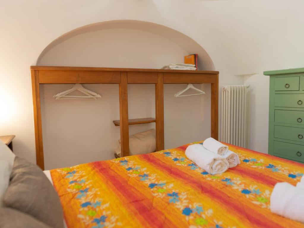 A bed or beds in a room at Historic Trulli Azzalema in Cisternino