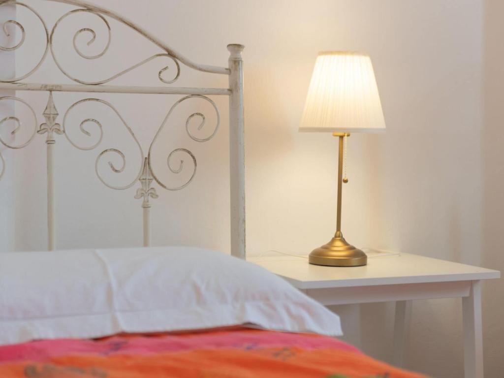 A bed or beds in a room at Historic Trulli Azzalema in Cisternino