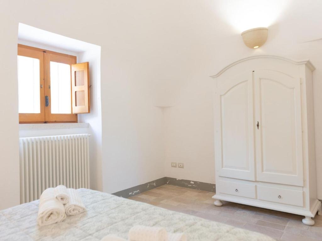 A bed or beds in a room at Historic Trulli Azzalema in Cisternino