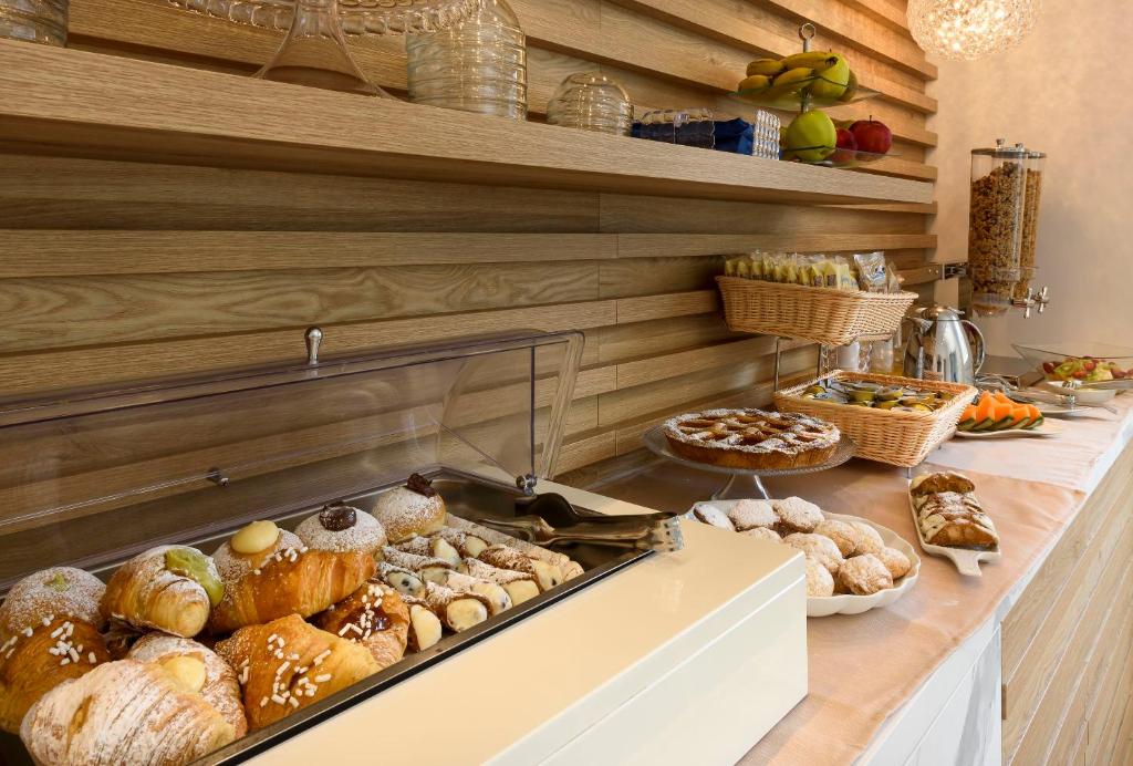 a bakery counter with various types of breads and pastries at Andromeda Hotel in San Vito lo Capo