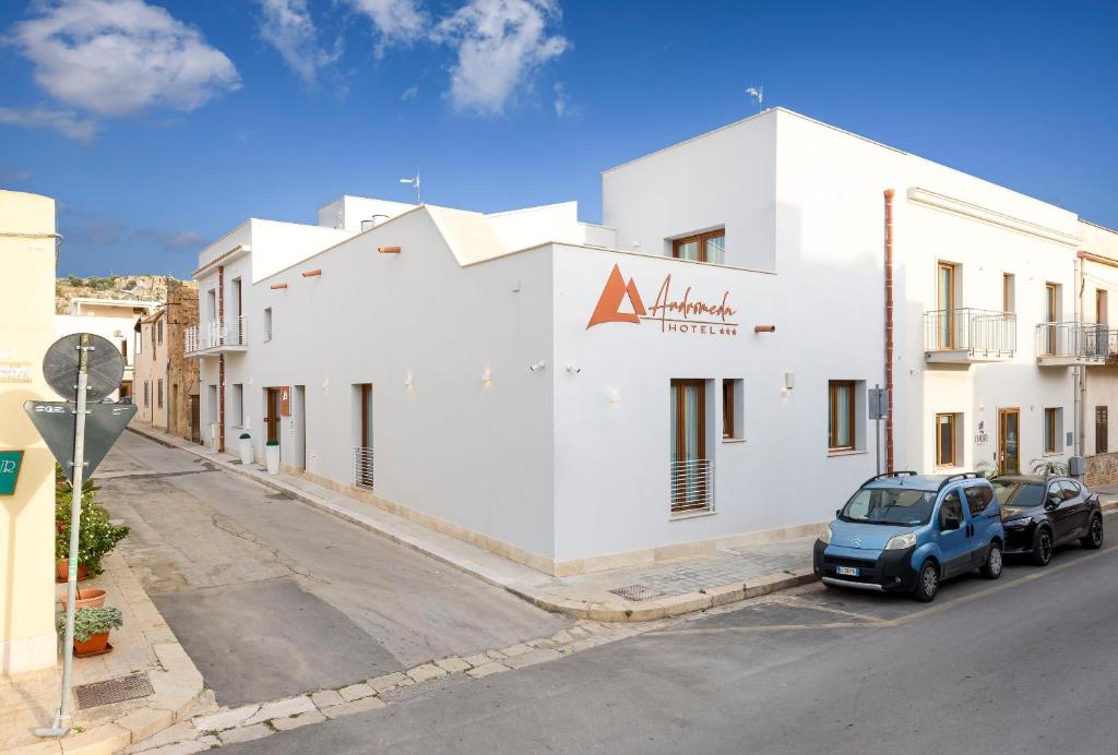 a white building on the side of a street at Andromeda Hotel in San Vito lo Capo