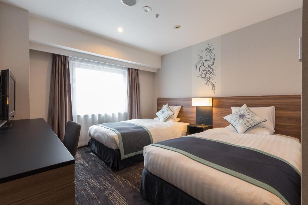 Postel nebo postele na pokoji v ubytování Matsue Excel Hotel Tokyu