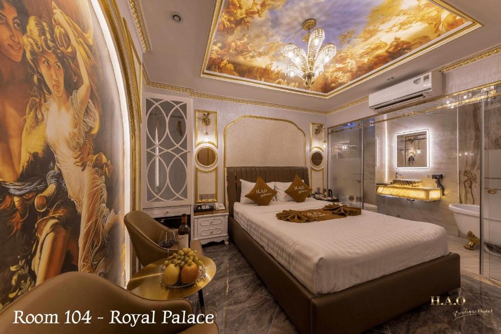 a bedroom with a bed and a painting on the ceiling at Hao Boutique Hotel in Ho Chi Minh City