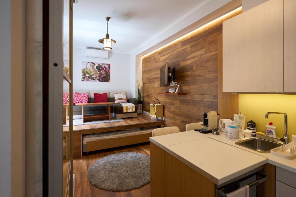 a kitchen with a living room in the background at Giselle Apartment in Budapest
