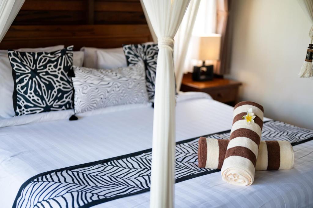 Postel nebo postele na pokoji v ubytování D'Puncak Villas Lembongan