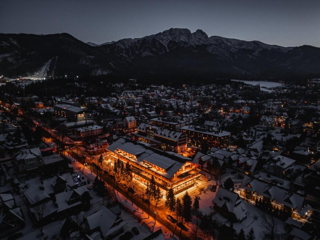 an aerial view of a city at night with mountains at Mountain Diamond Resort in Zakopane