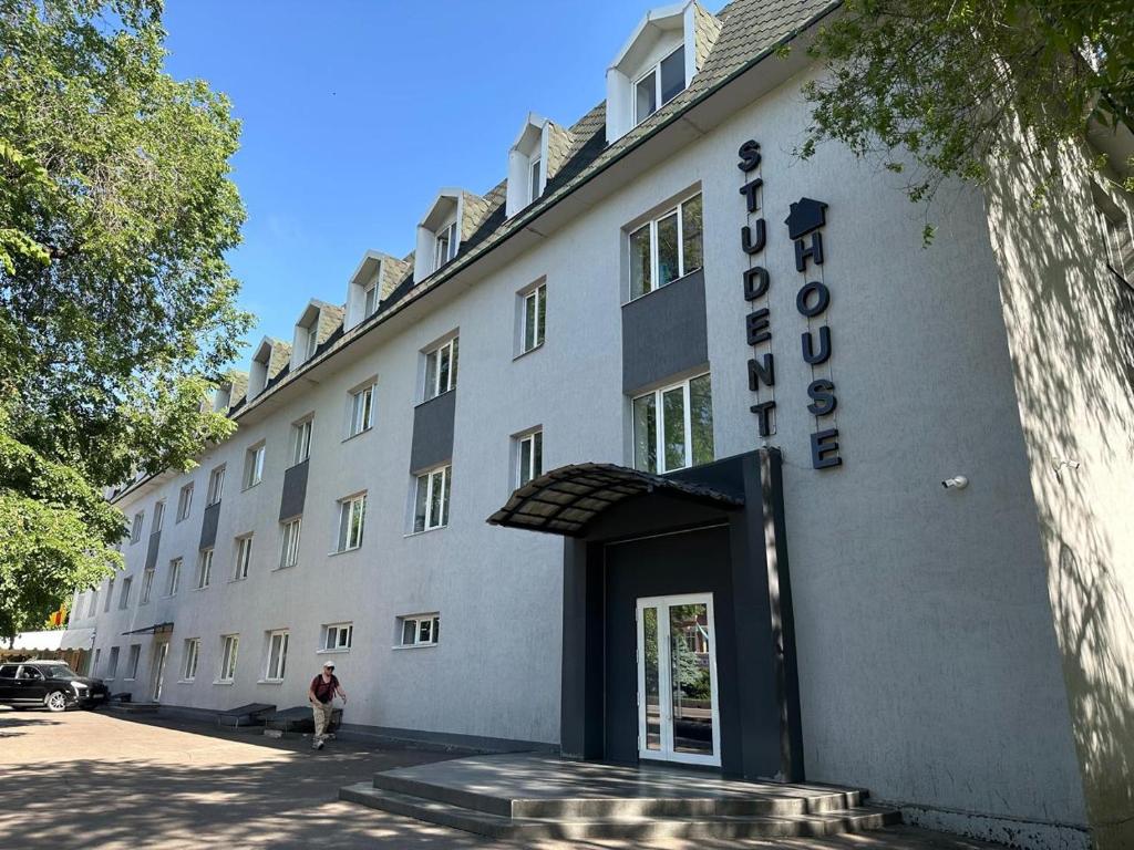 a person standing in front of a building at Student Castle Almaty hostel in Almaty