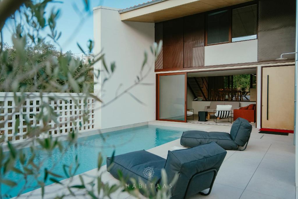a swimming pool in the middle of a house at Habitals villa in Syvota