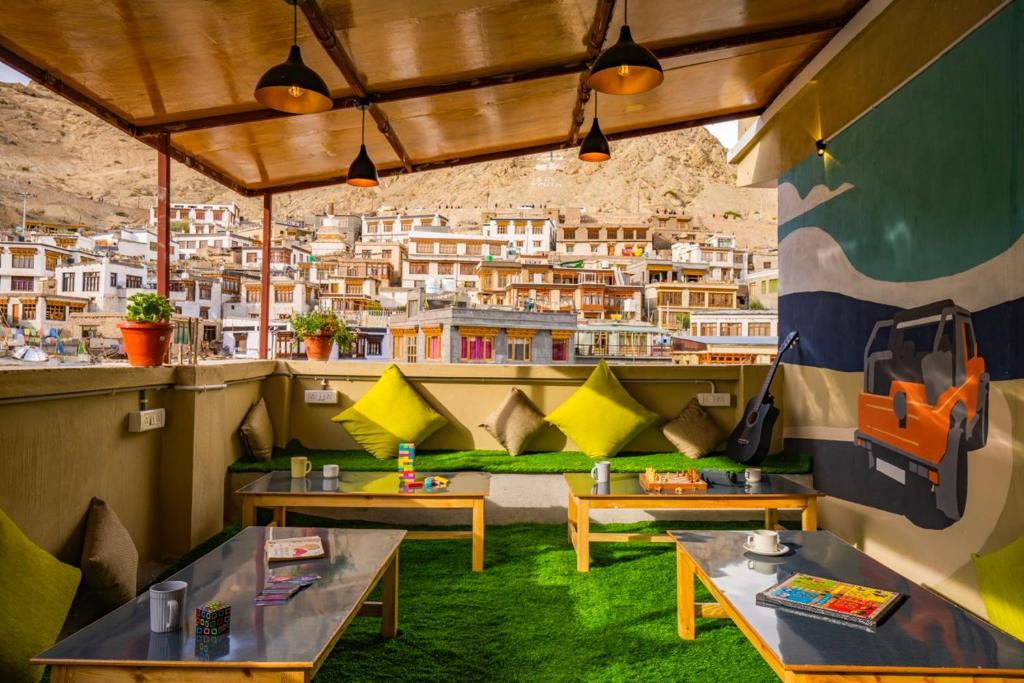 a restaurant with tables and a view of a city at LeHostel in Leh
