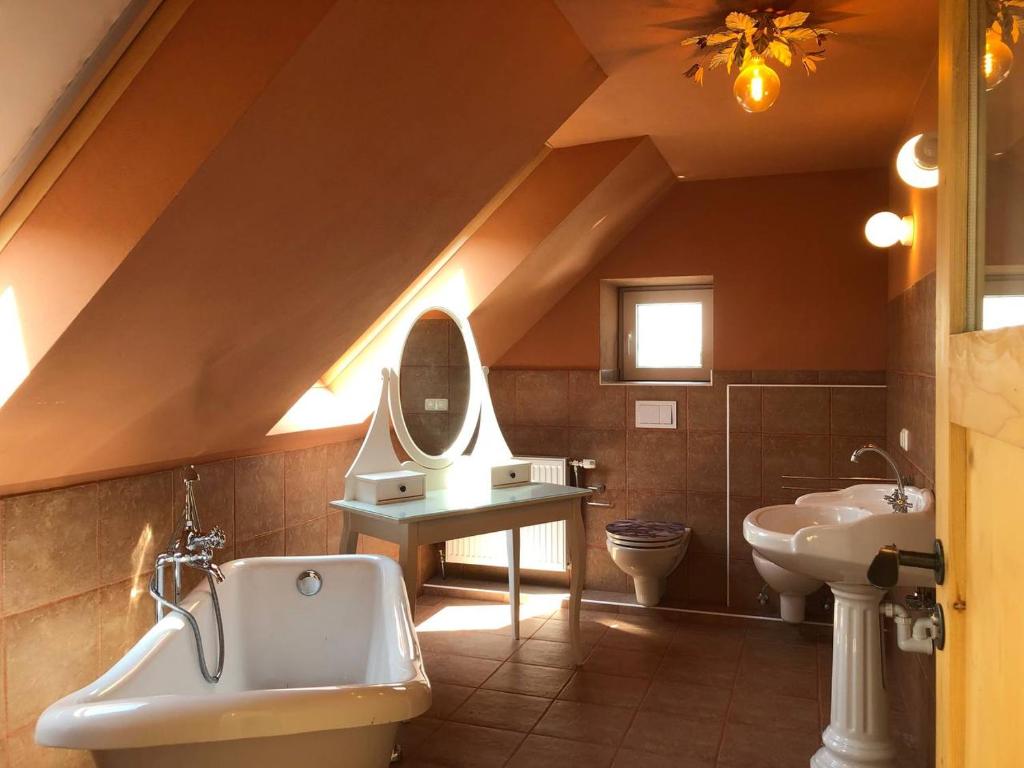 a attic bathroom with a sink and a toilet at Zimmer auf dem Land in Sankt Margarethen an der Raab