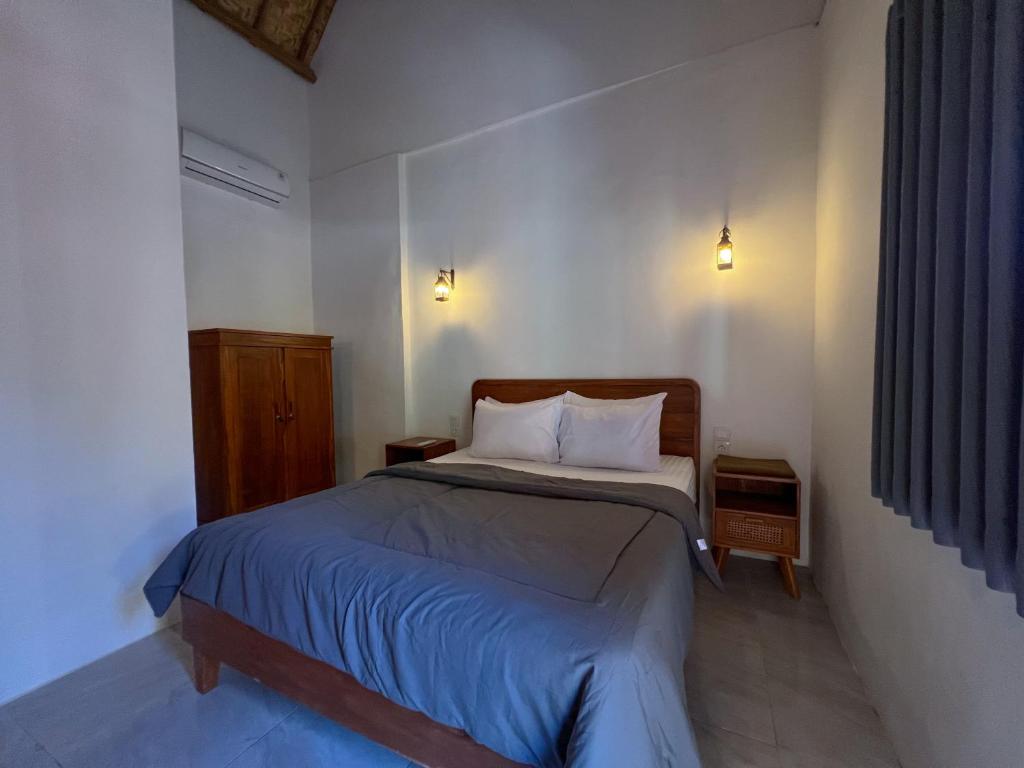 Postel nebo postele na pokoji v ubytování Bae Gili Inn