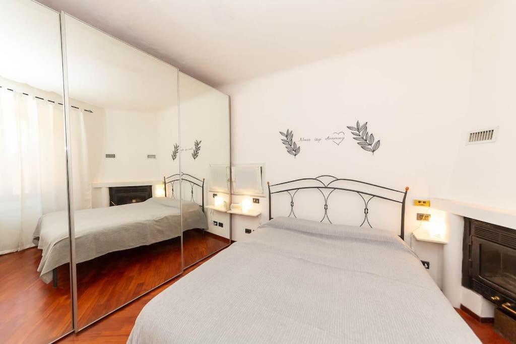 a bedroom with two beds and a fireplace at Il nido appartamento nel cuore del centro storico in Luino