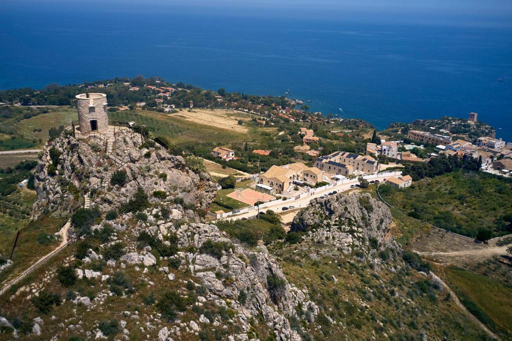 a small town on top of a mountain at Baglio Dello Zingaro in Scopello