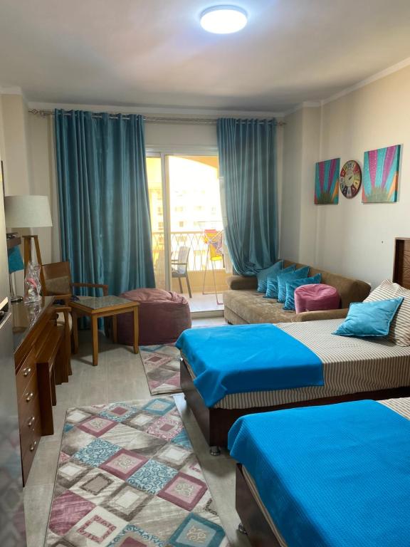 a room with two beds and a living room at Aqua View north coast for Egyptians only in El Alamein