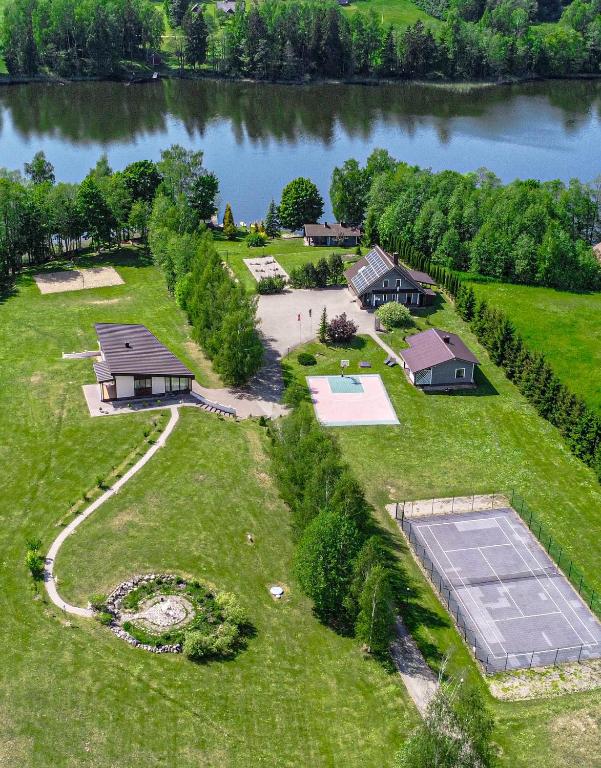 an aerial view of a house on the shore of a lake at Green Harmony in Antalgė