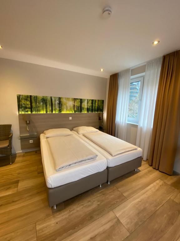 Postel nebo postele na pokoji v ubytování Hotel Scheid