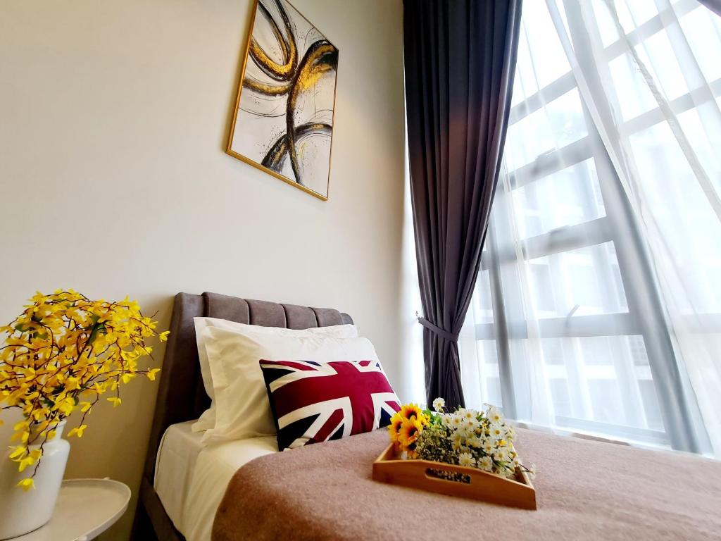 a bedroom with a bed and a window with flowers on it at Duplex Eko Cheras Kuala Lumpur City Center Tun Razak Exchange Mall in Kuala Lumpur