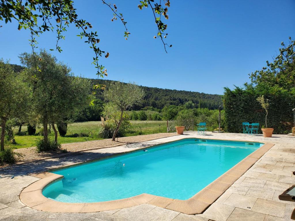 a swimming pool in a yard with trees at Moulin de Bonfilhon in Cornillon-Confoux