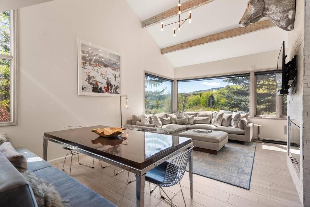 a living room with a couch and a table at Snowmass Villas 3 bedroom plus loft in Snowmass Village