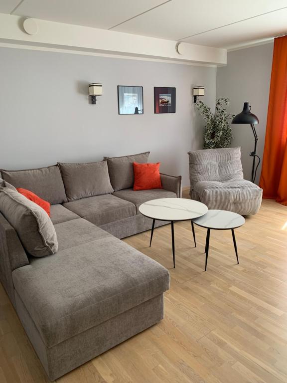 a living room with a couch and two tables at Karusselli 66a in Pärnu