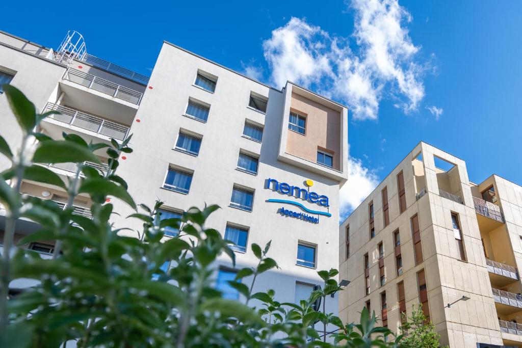 a building with the name of the hotel at Nemea Appart Hotel Grand Cœur Nancy Centre in Nancy