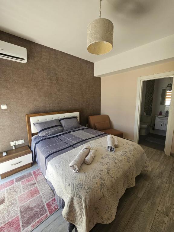 a bedroom with a bed with two towels on it at Spacious Beachfront Two-Bedroom Apartment in Caesar Beach in Boghaz