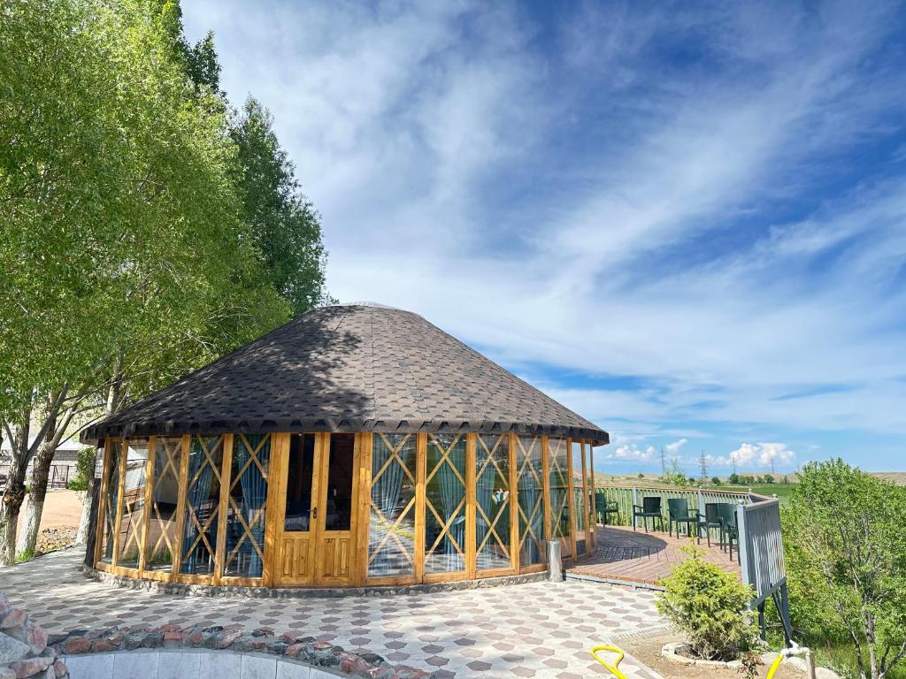 a wooden gazebo with a roof at Eco Resort Kaiyrma in Bokonbayevo