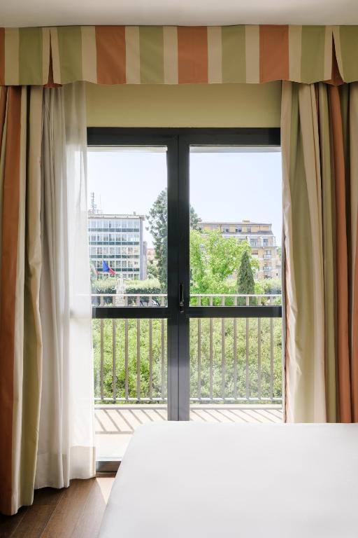 A bed or beds in a room at Hotel dei Cavalieri Caserta - La Reggia