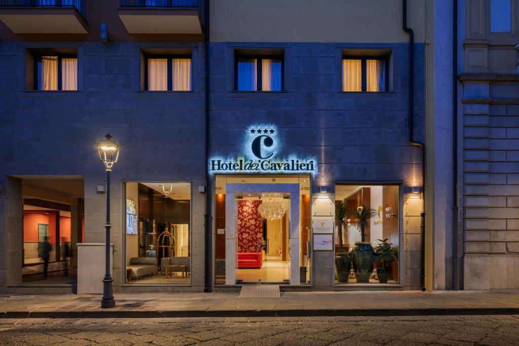 a facade of a hotel with a sign on it at Hotel dei Cavalieri Caserta - La Reggia in Caserta