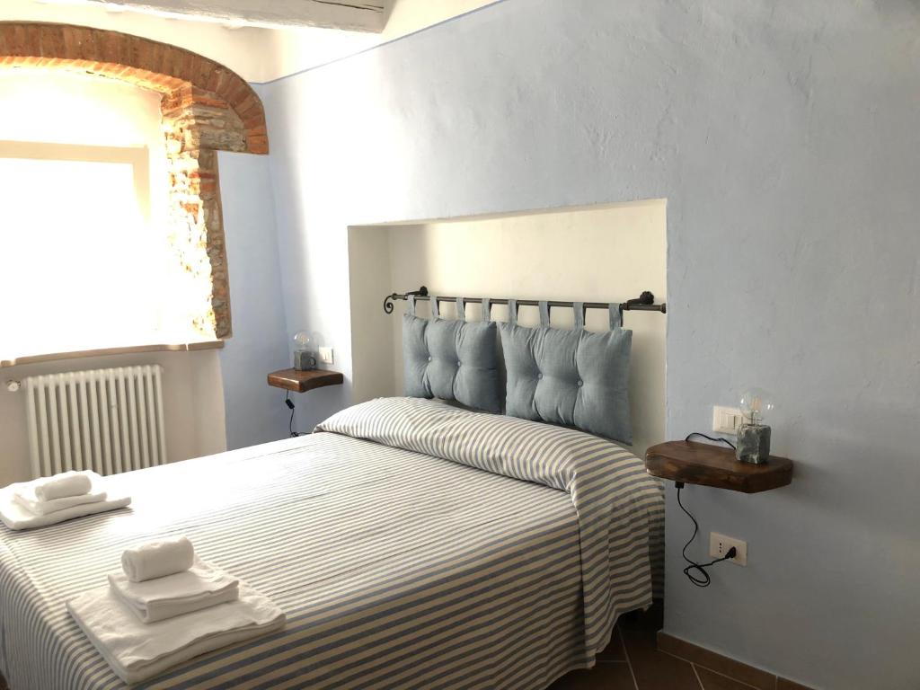Postel nebo postele na pokoji v ubytování Le Dame del Borgo