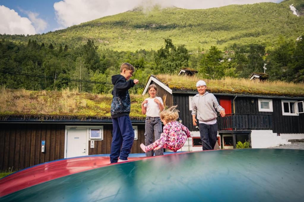a group of children standing on top of a trampoline at Vinje Camping in Geiranger