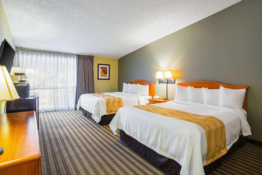 a hotel room with two beds and a window at Quality Inn & Suites NRG Park - Medical Center in Houston