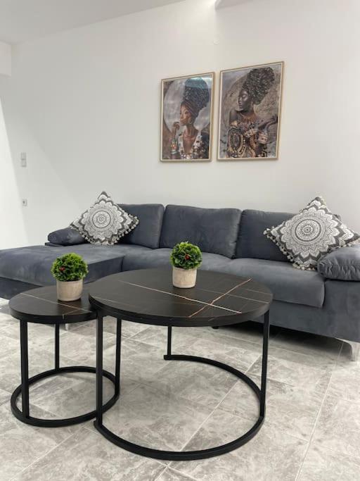 a living room with a blue couch and a table at BeeHouse in Kalithies