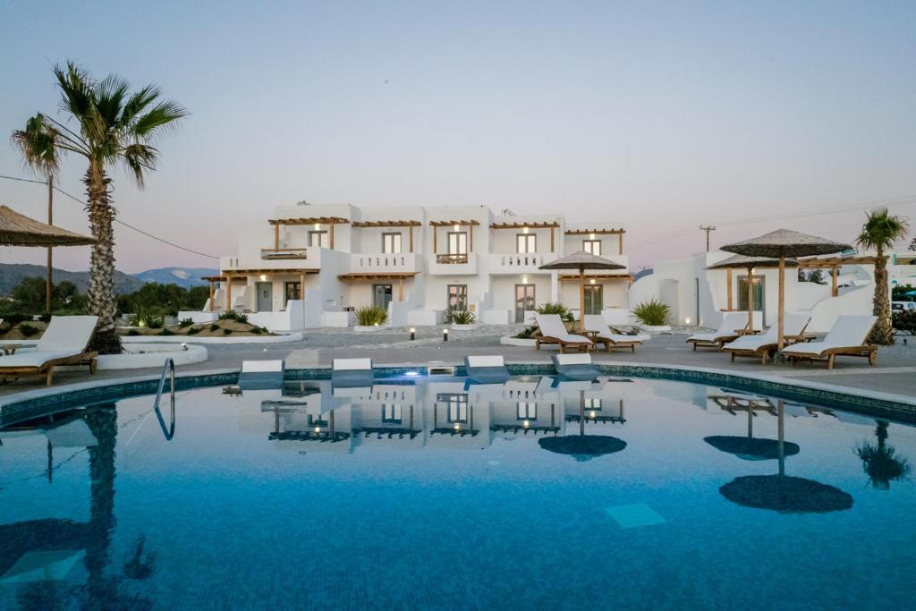 a swimming pool in front of a villa at Naxos Finest Hotel & Villas in Naxos Chora