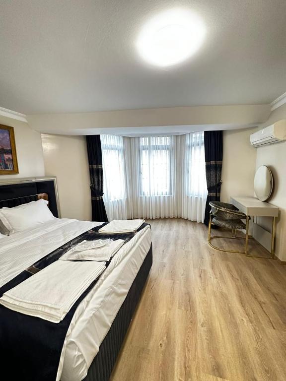Ένα ή περισσότερα κρεβάτια σε δωμάτιο στο New Hotel Harbiye Studio