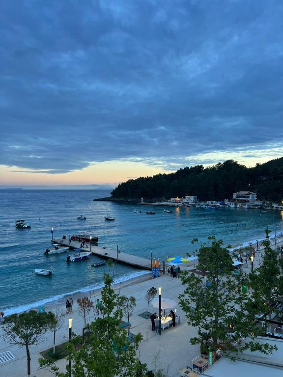 a view of a beach with boats in the water at Red Sunset Apartment in Himare