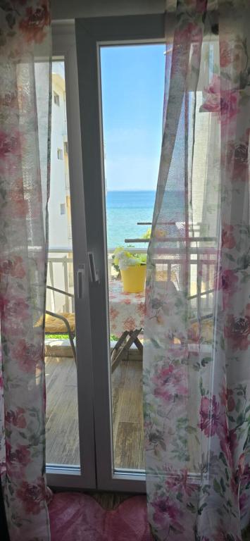 a door with a view of the ocean from a balcony at Perea Silvi suite in Perea