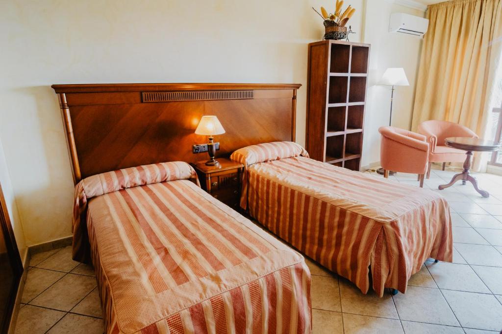 Postel nebo postele na pokoji v ubytování Hotel Hacienda Don Manuel