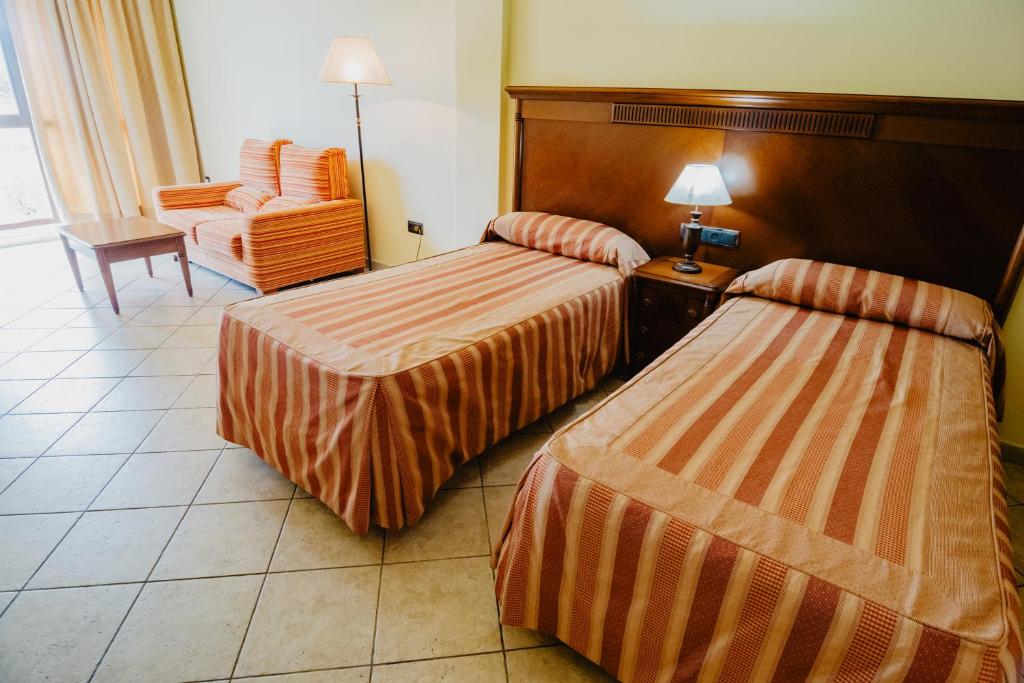 Postel nebo postele na pokoji v ubytování Hotel Hacienda Don Manuel