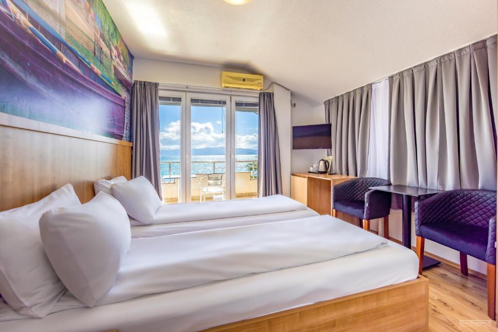 una camera d'albergo con due letti e una finestra di Villa Tino a Ohrid