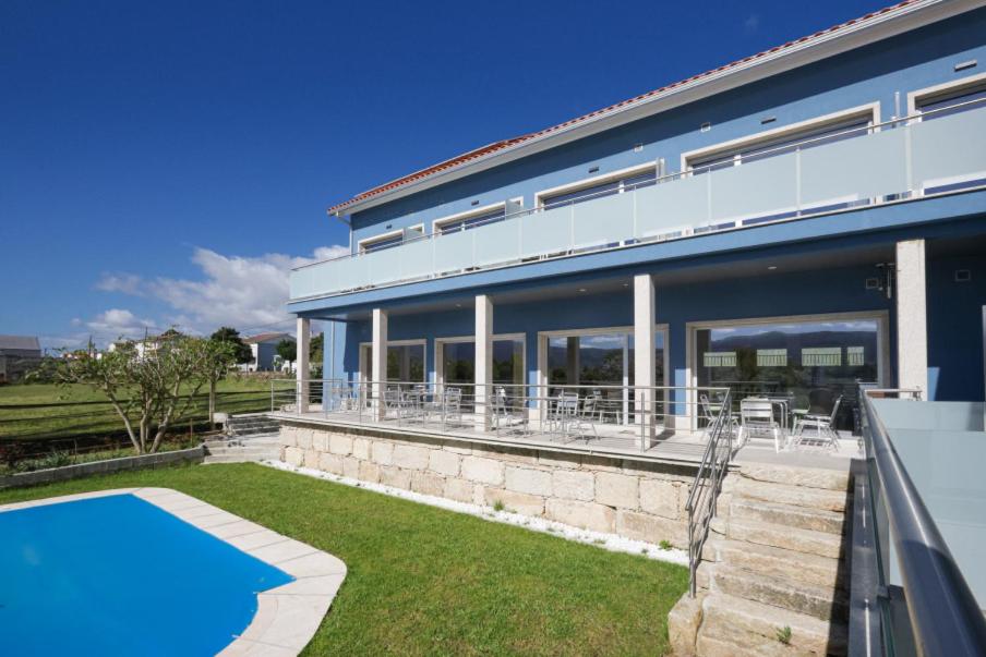 an exterior view of a house with a swimming pool at Refúgio da Garça in Chaves