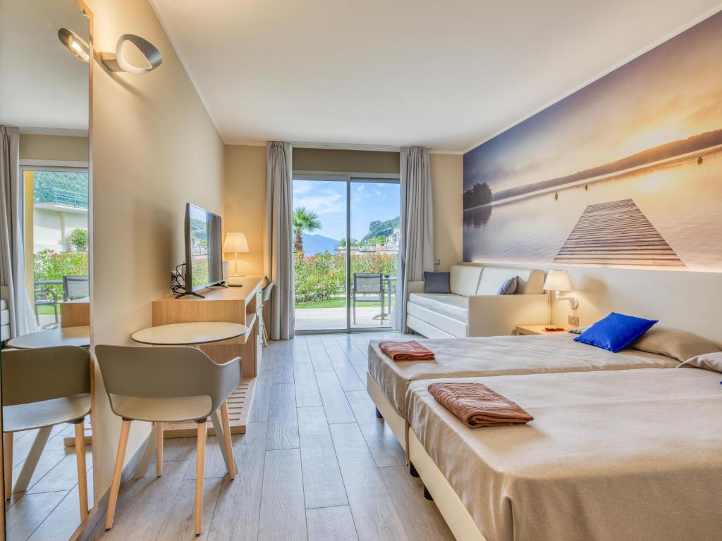 Postel nebo postele na pokoji v ubytování Hotel Cristina