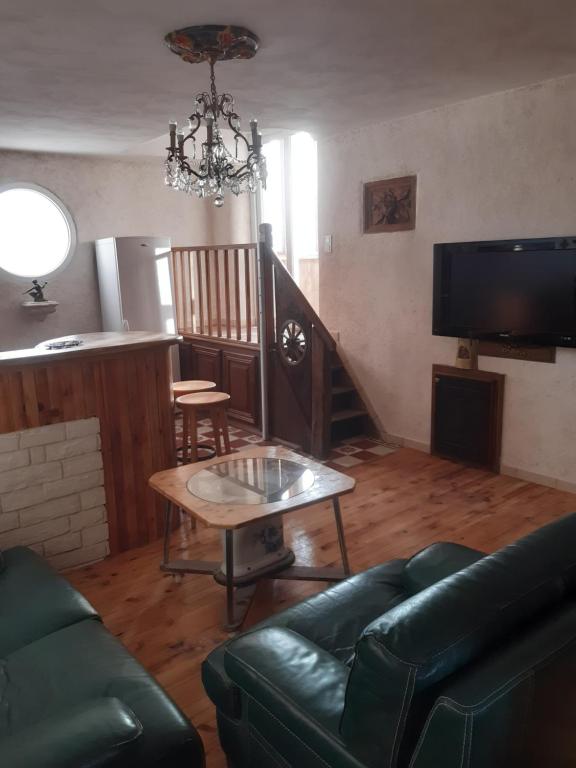 a living room with a couch and a table at La chanvriere in Manheulles