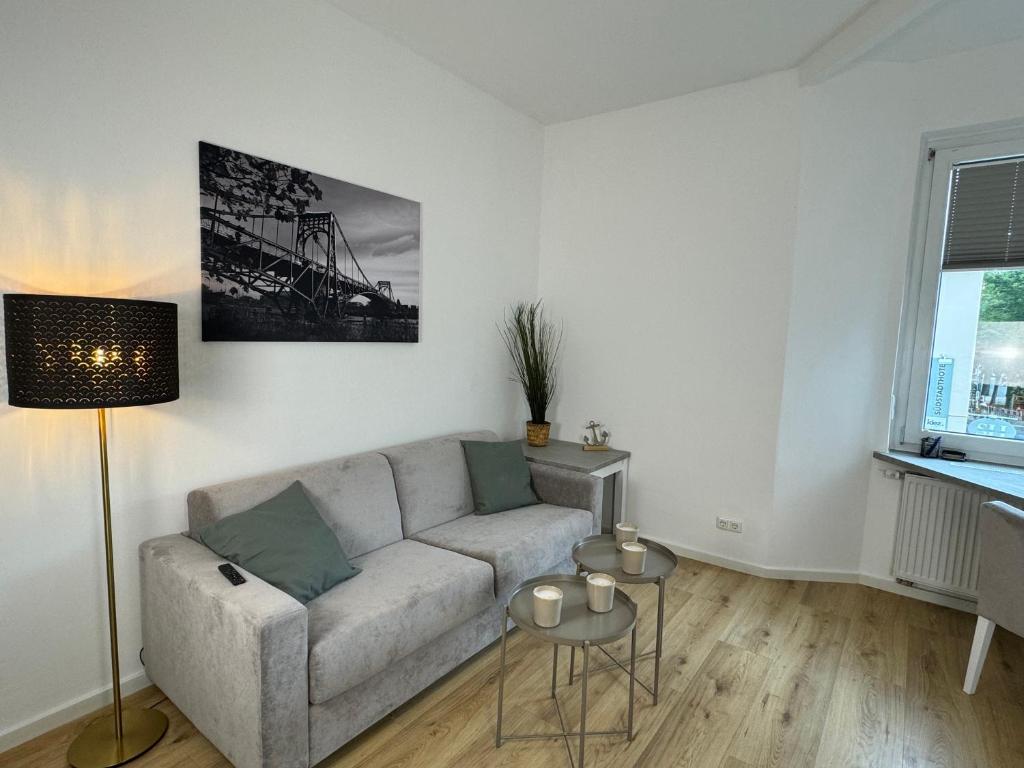 a living room with a couch and a table at Kaiser Apartment am Meer 1 in Wilhelmshaven