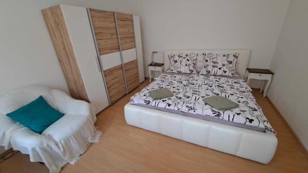 a small bedroom with a bed and a chair at Haus Piroschka in Mörbisch am See