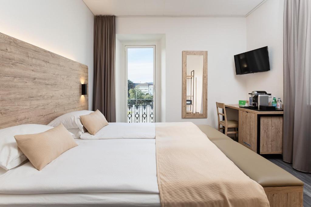 Postel nebo postele na pokoji v ubytování Hotel Du Lac