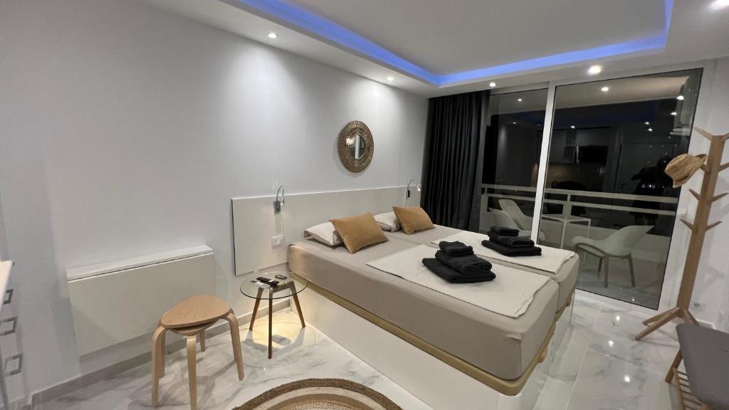 a white bedroom with a bed and a balcony at Tenerife Sea View Sun Beach Apartment 220 in Playa Fañabe