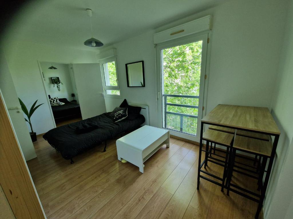 a living room with a couch and a table at Appartement avec vue sur le lez in Montpellier