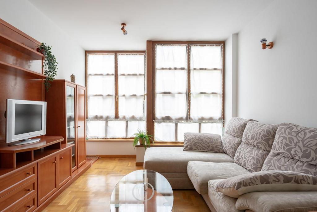 a living room with a couch and a tv at Appto Scott en Ribadesella VUT5829AS in Ribadesella