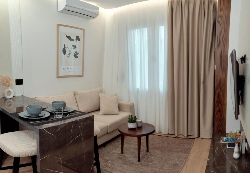 a living room with a couch and a table at Godija Central Tirana 1 in Tirana
